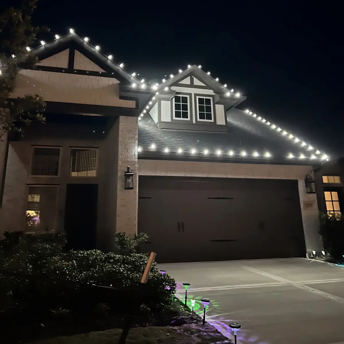 Warm white holiday lights outlining a residential roof
